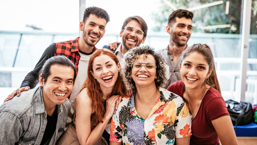 diverse group of adults happy and posing for a group photo