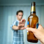 Pacific Sky - Relapse Prevention Tips - Edited. A man puts his hand out as a stop signal to someone handing him an alcoholic beverage