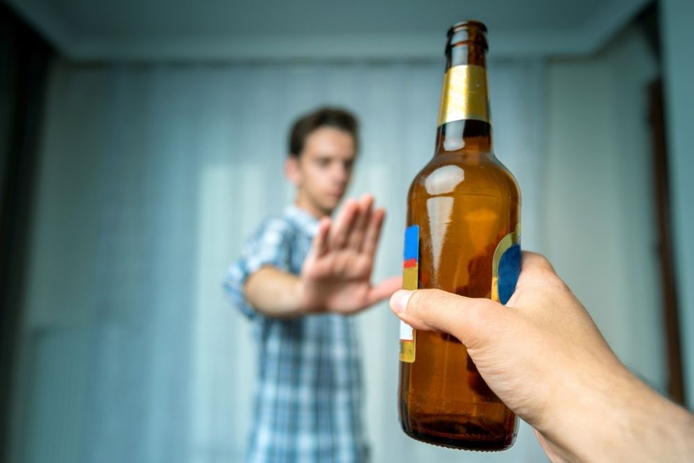 Pacific Sky - Relapse Prevention Tips - Edited. A man puts his hand out as a stop signal to someone handing him an alcoholic beverage